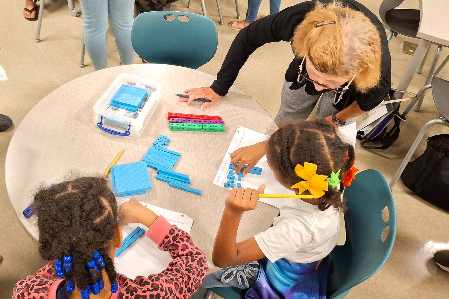 "A teacher works with two students on using CGI in math."