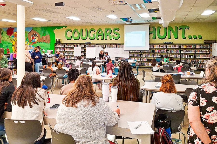 Large classroom of educators listening to a presentation