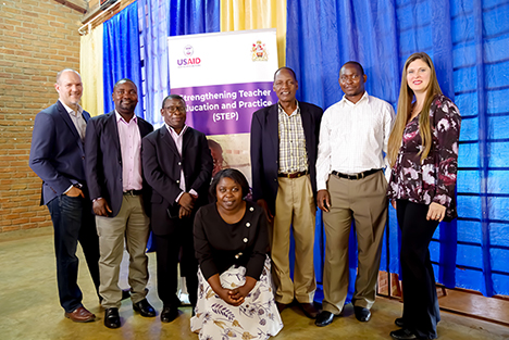 "Jeremy Koch (STEP Chief of Party), Dr. Symon Winiko, Associate Professor Allan Lipenga, Dr. Amos Chauma, Mr. Patrick Kapito, Dr. Adrienne Barnes-Story (STEP Project Director). Squatting: Dr. Mervis Kamanga posing next to a banner for the USAID funded STEP project in Malawi."