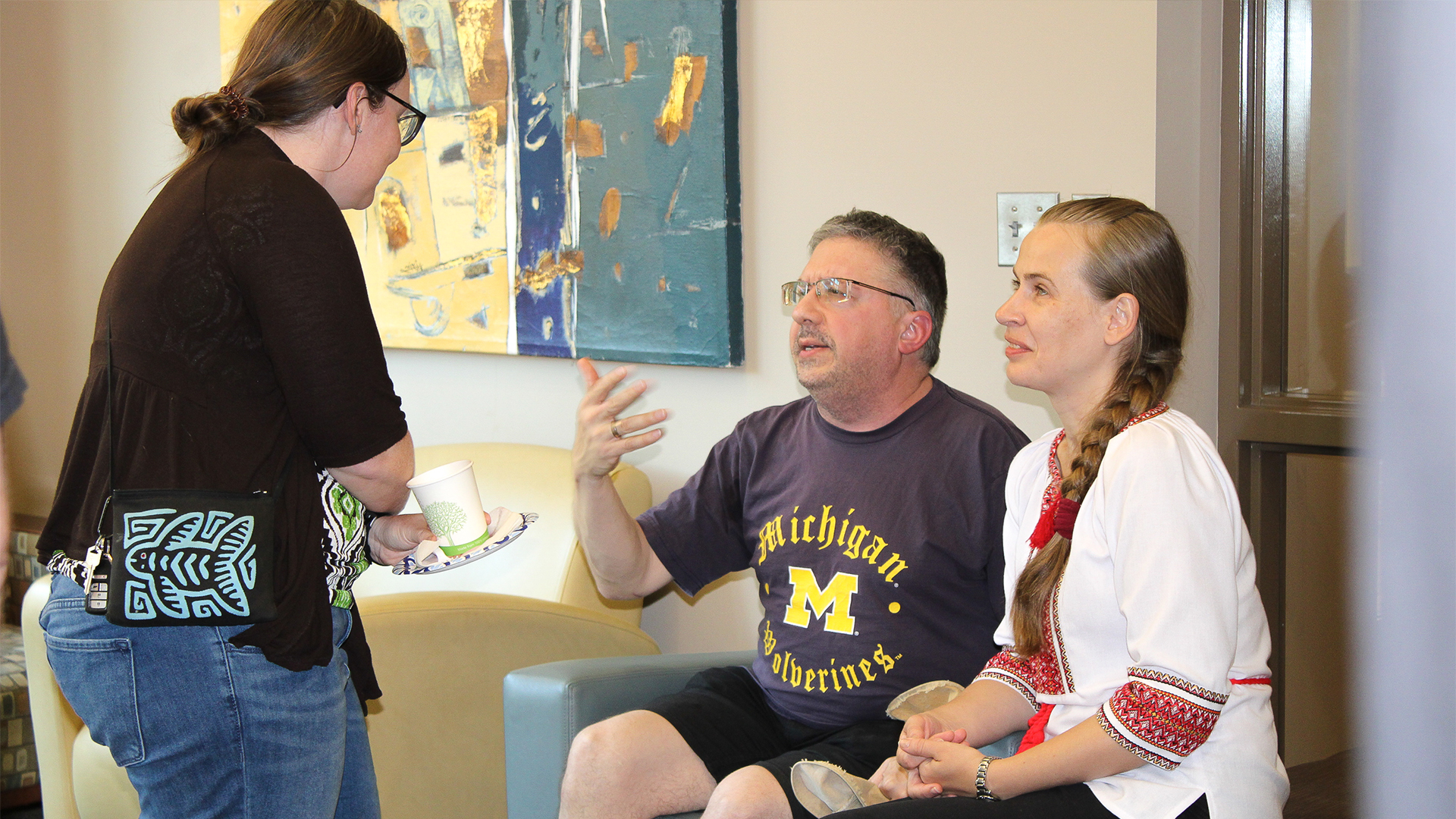 "Dr. Safonova seated talking with two people at FSU's International Coffee Hour."