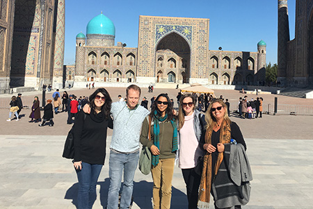 "Group photo in front of a building in Uzbekistan"