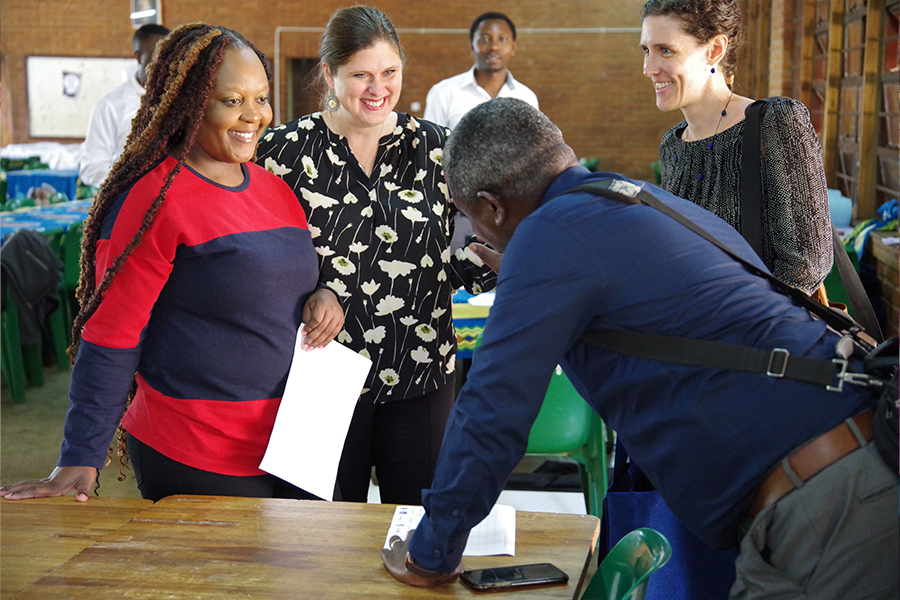"Dr. Adrienne Barnes-Story in discussion with a small group at a conference"