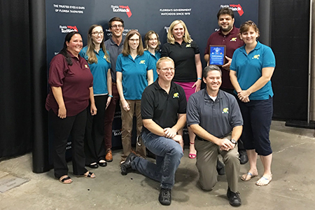 "LSI staff posing with their Tax Watch award"
