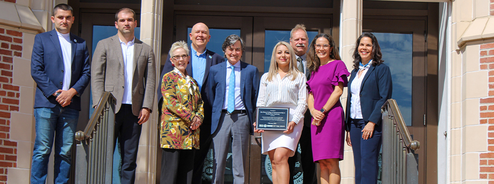 Group photo on the steps of the Westcott Building with the Provost.