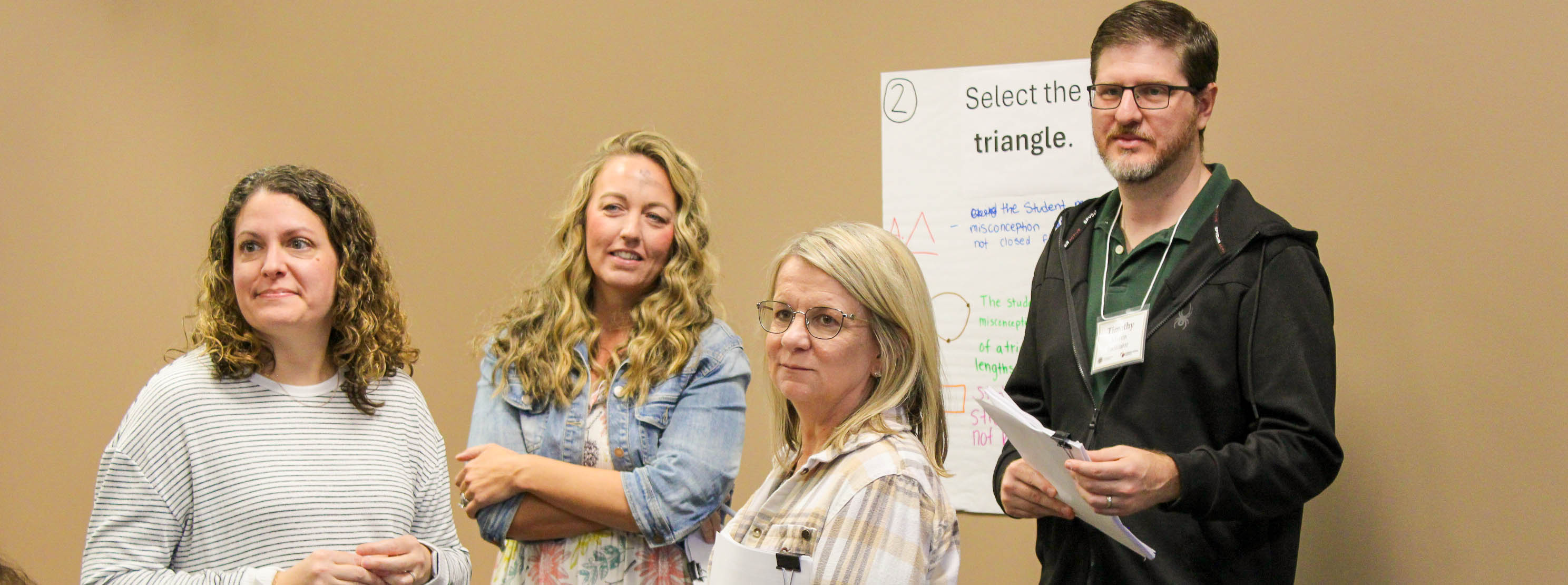 Small group working together during an math assessment writing workshop in Tallahassee.