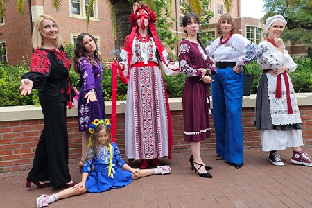 A group of women outside posing and modeling vyshyvankas at a Vyshyvanka Day celebration.