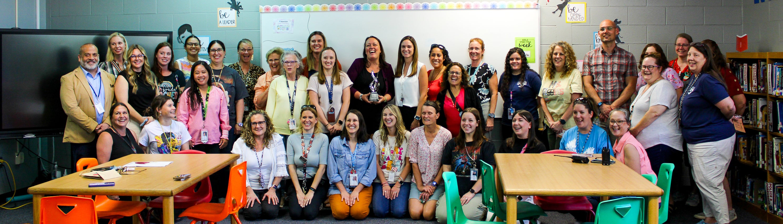 Group photo of the teachers and staff at Holley-Navarre Intermediate school posing with Anna Prindle. 