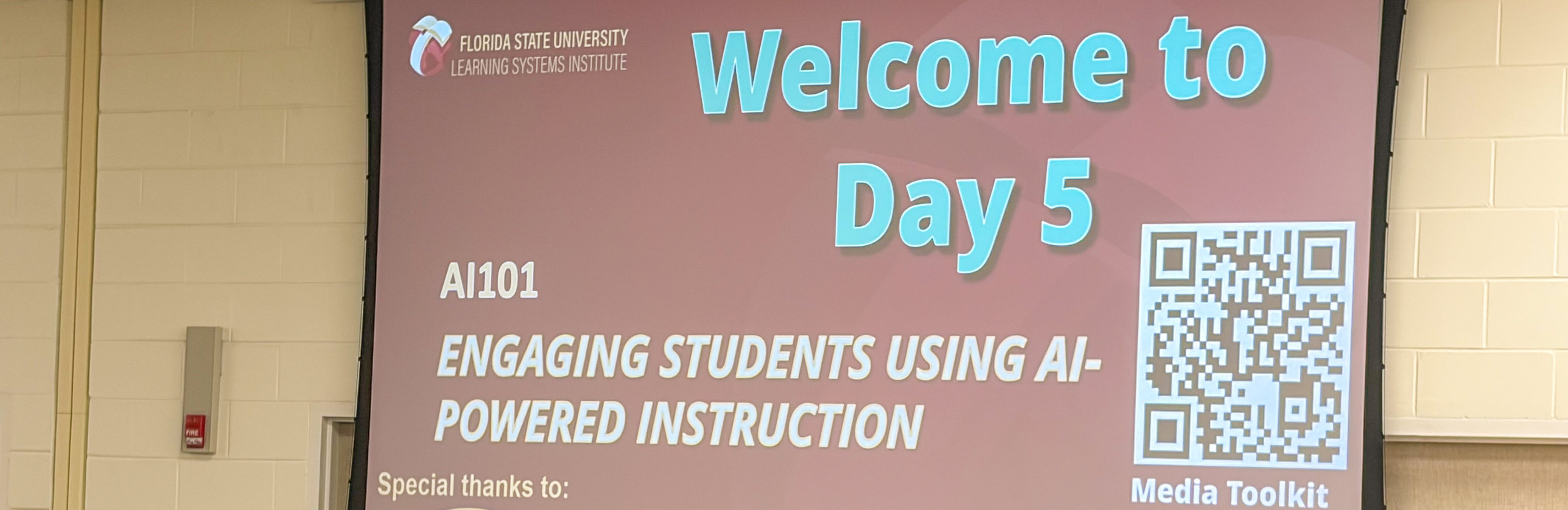 Large projection screen with information about Day 5 of the InSPIRE AI 101 workshop.