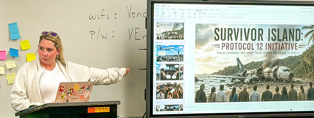 Woman at a podium pointing to a large digital display screen during an InSPIRE AI education session.