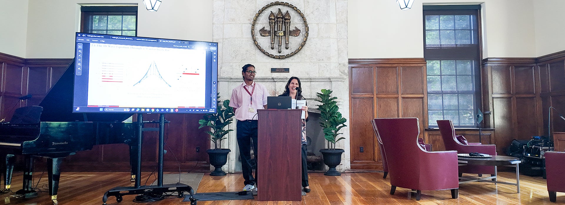 Vilma Fuentes at a podium with a member of the VSPP. 