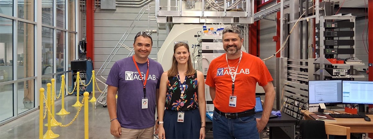 Two fellows from Ukraine pose for a photo at the National High Mag Lab with a woman.