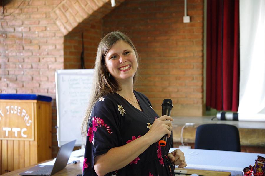 Adrienne Barnes-Story with a microphone during a presentation 