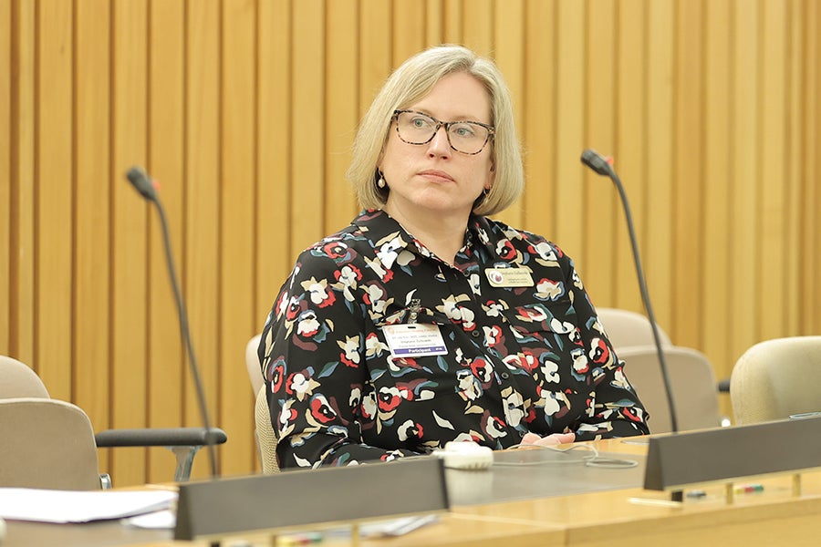 Stephanie Simmons Zuilkowski at a conference sitting and listening to a presenter