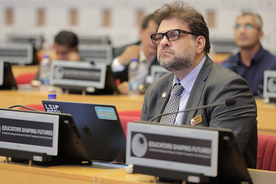 Rabieh Razzouk at a conference sitting in front of his computer.