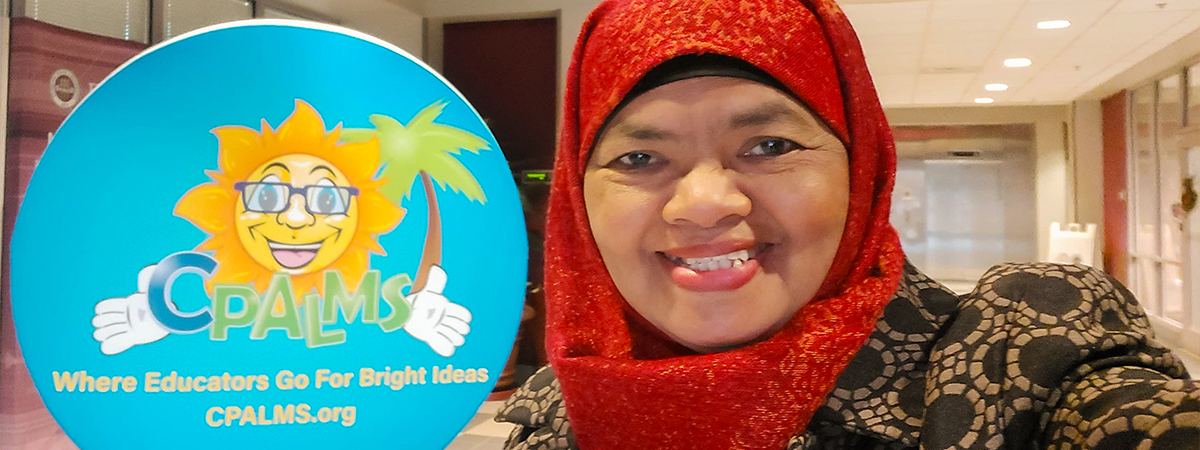 Dr. Ely selfie photo in front of a large circular CPALMS sun logo sign.