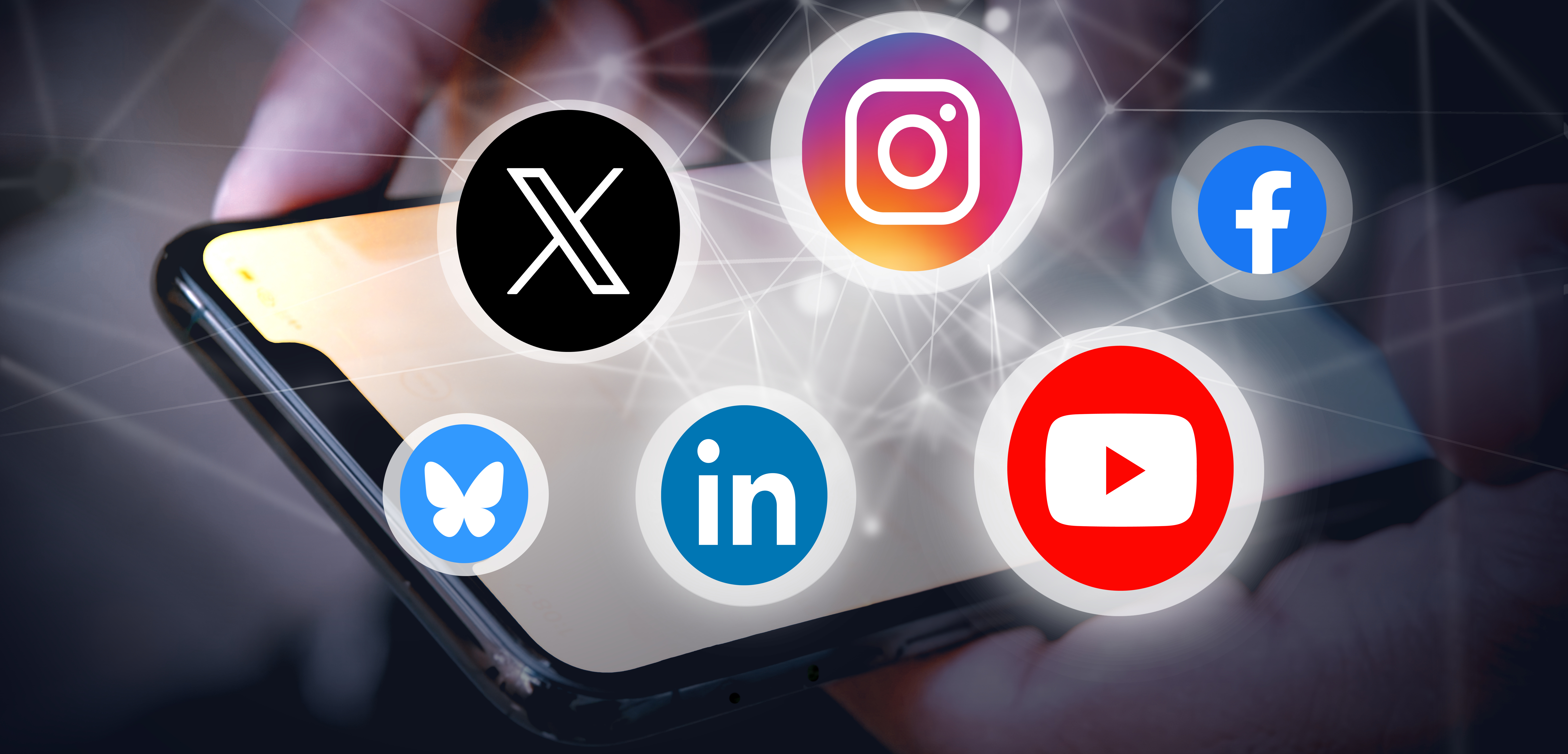 Photo of a cell phone with circles containing logos for social media services. 