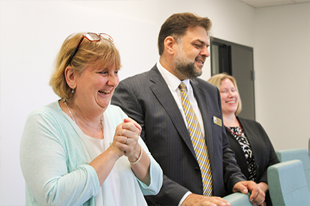 "Gena St. John, Rabieh Razzouk, and Dr. Stephanie Zuilkowski laughing""