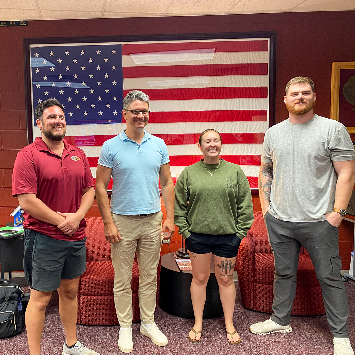 Dr. Dmytro Stepanskyi at the FSU Veteran's Center posing for a photo with three others. 