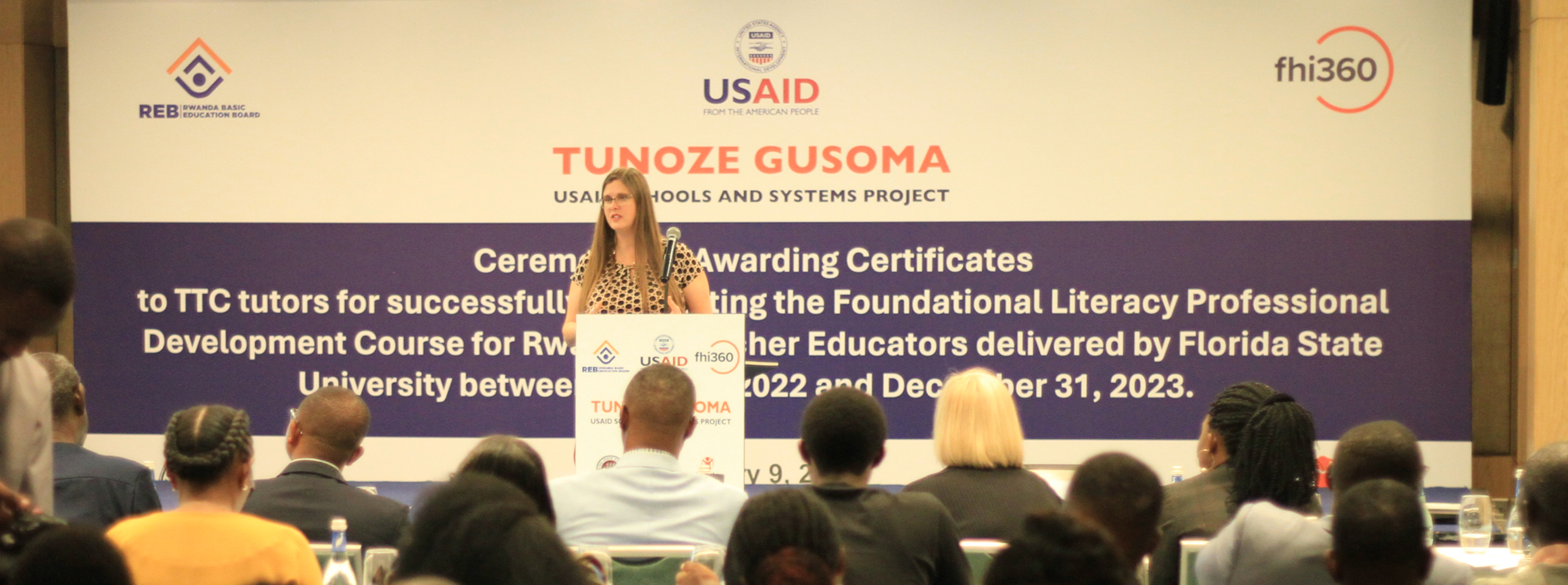 Dr. Adrienne Barnes-Story addressing a crowd in Rwanda on the Tunoze Gusome project.