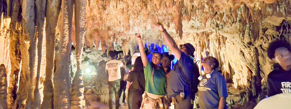 A group outing inside a Florida cavern as participants explore stalactite and stalagmite,