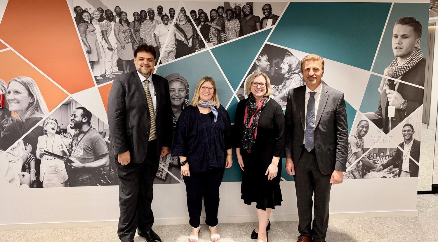 Rabieh Razzouk and Stephanie Zuilkowski pose with IREX leadership at IREX headquarters.