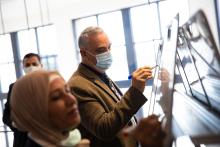 Two people working on white boards