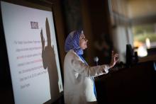 A women with a microphone presenting