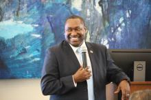 Man smiling with a microphone in hand