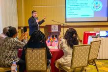 Man presenting to a group in a ballroom in Barbados