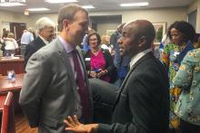 Group of people mingling and talking after a presentation