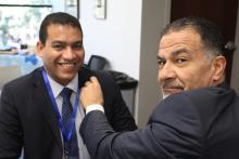 One man holding on to another's suit jacket lapel