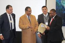 Santa Fe College President looking at a gift from the CCAP group