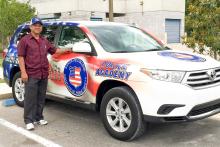 Man standing next to a police academy car at Santa Fe College