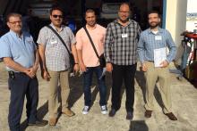 Group of four members of the CCAP Egypt delegation posing with a member of the Santa Fe College staff