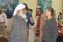 CCAP Pakistan participant talking with a student