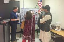 CCAP Pakistan members standing in front of a powertrain control board