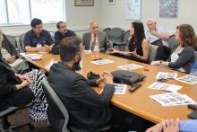 CCAP Pakistan group members sitting around a table in a discussion
