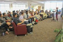 A Santa Fe College student presenting to a room that includes members of the CCAP Pakistan group