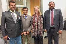 Four people posed for a group photo