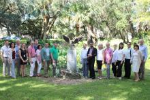 Group photo outside of Santa Fe College next to an eagle statue