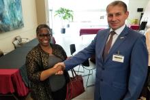 A woman and a man shaking hands