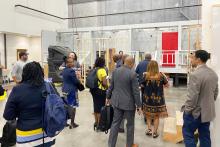 CCAP South Africa group photo inside a large room with a facade of a building at the front of the room at Valencia College