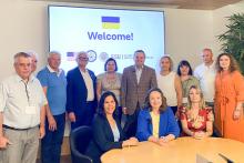 Group photo in front of a projection screen.