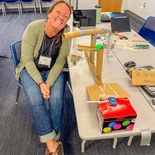 Anna Prindle sitting at a desk at a workshop.