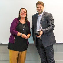Anna Prindle receiving a silver trophy from Rabieh Razzouk.