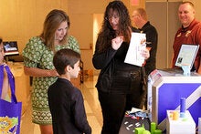 Carrie Meyeres speaking with a woman and a child at FSU Day at the Capitol.