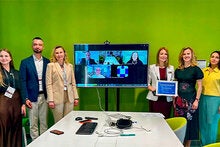 Dr. Anna Romanova standing with a group at a conference in Lviv, Ukraine.