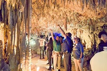 A group outing inside a Florida cavern as participants explore stalactite and stalagmite,