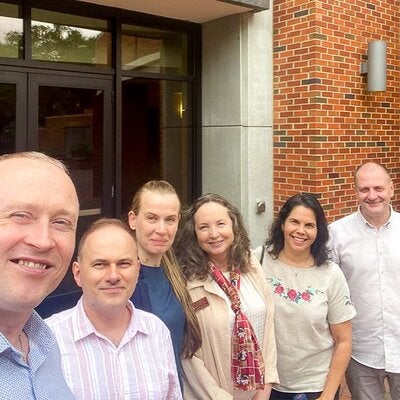 Group photo with Dr. Dina Vyortkina, Dr. Vilma Fuentes and BridgeUSA participants in front of Anne's College on the FSU campus. 