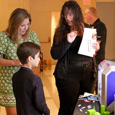 Carrie Meyeres speaking with a woman and a child at FSU Day at the Capitol.